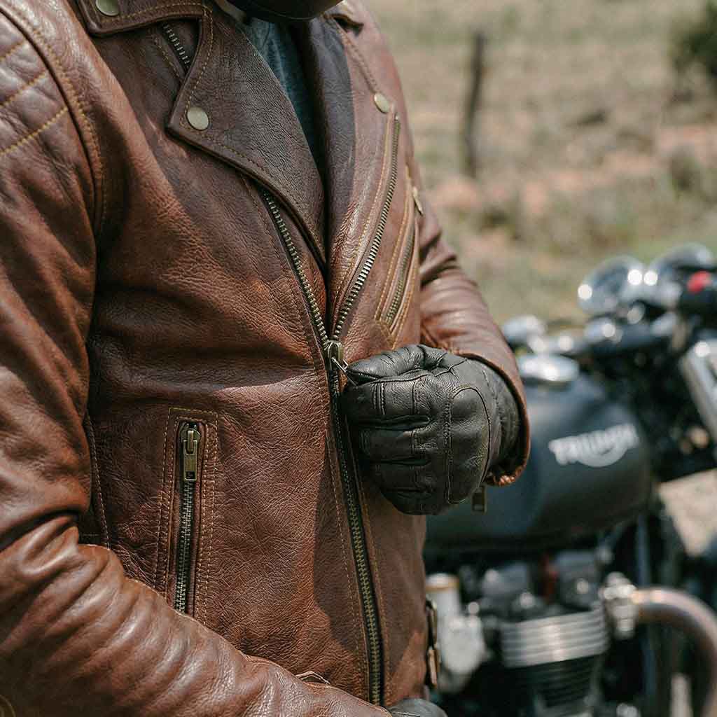 Rider wearing a motorcycle leather jacket and gloves