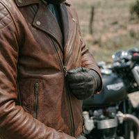 Rider wearing a motorcycle leather jacket and gloves