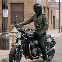 Rider wearing leather jacket on motorcycle